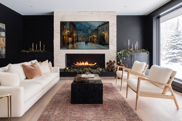Alpine Noel Christmas village artwork displayed on Samsung Frame TV above modern fireplace in festive living room with white sofa, holiday garland, and candles